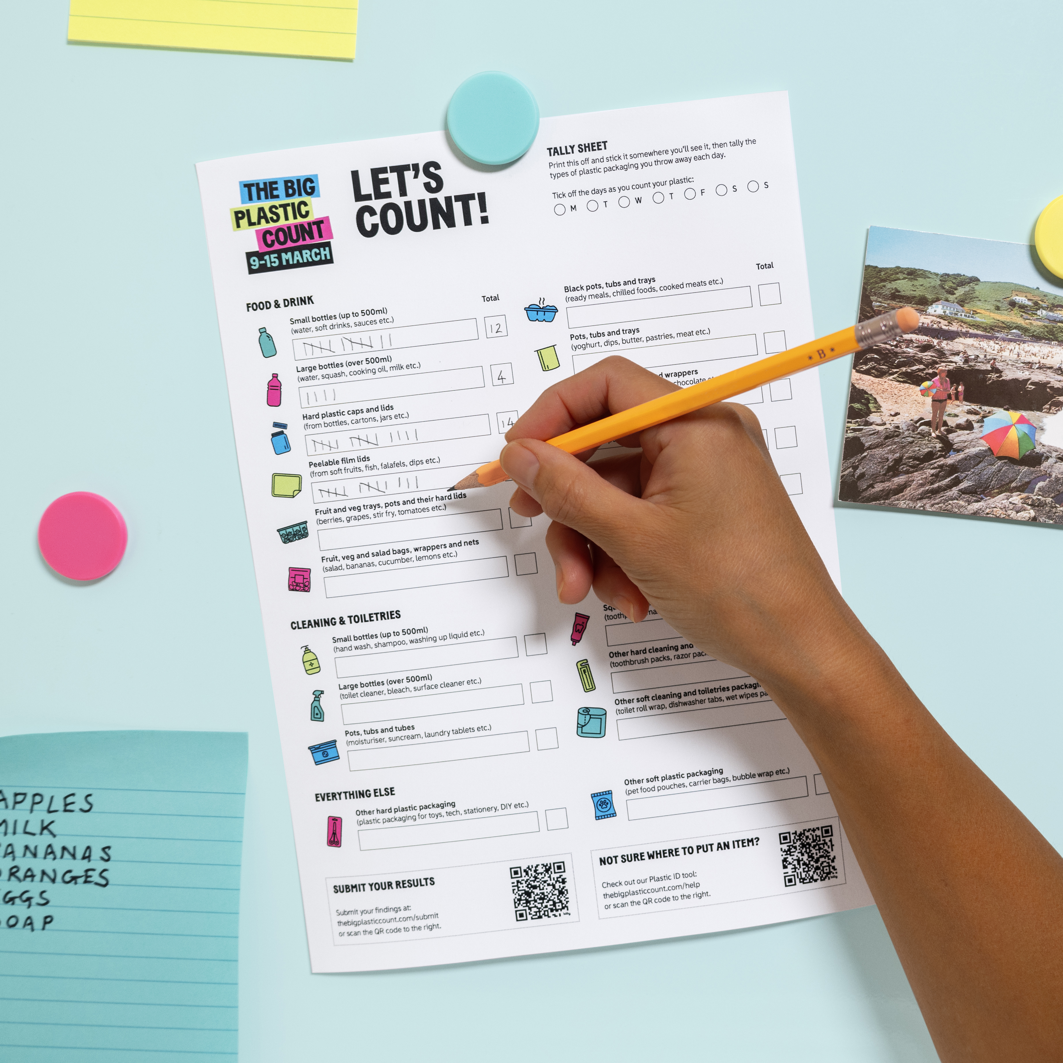 A hand uses a pencil to fill in a Big Plastic Count count sheet