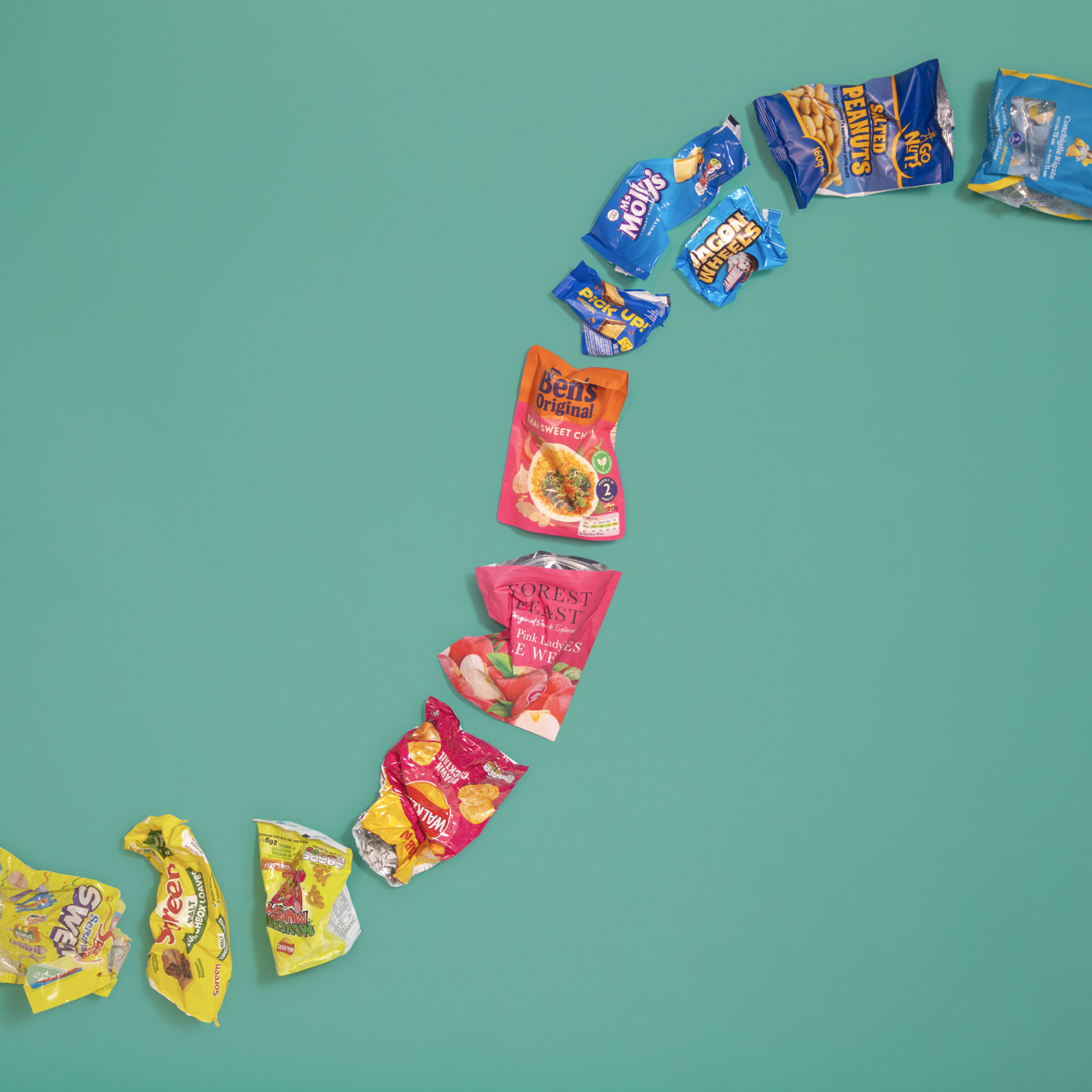 A picture of colourful plastic packaging forming an winding path in the shape of an S