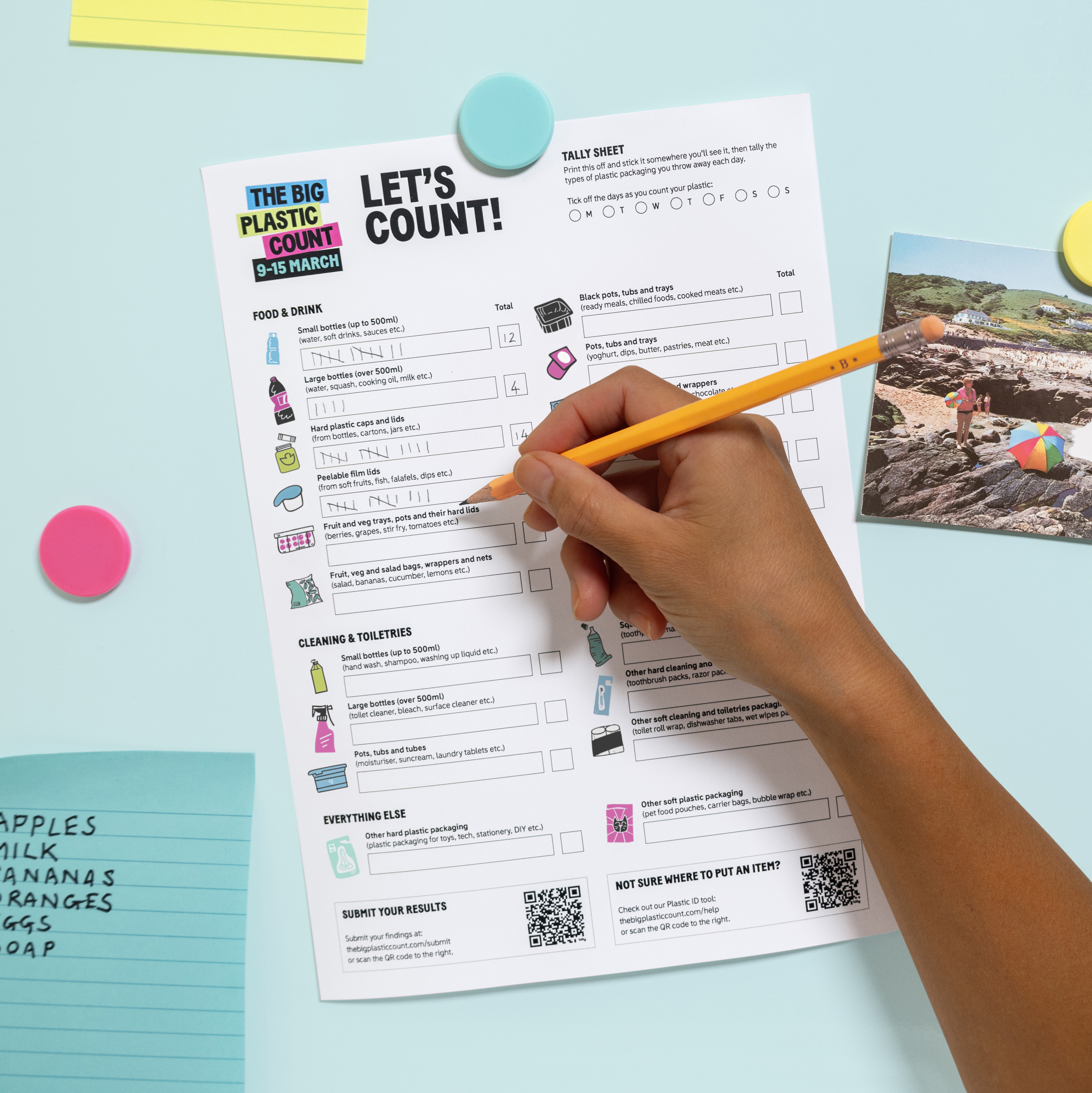 A hand uses a pencil to fill in a Big Plastic Count count sheet