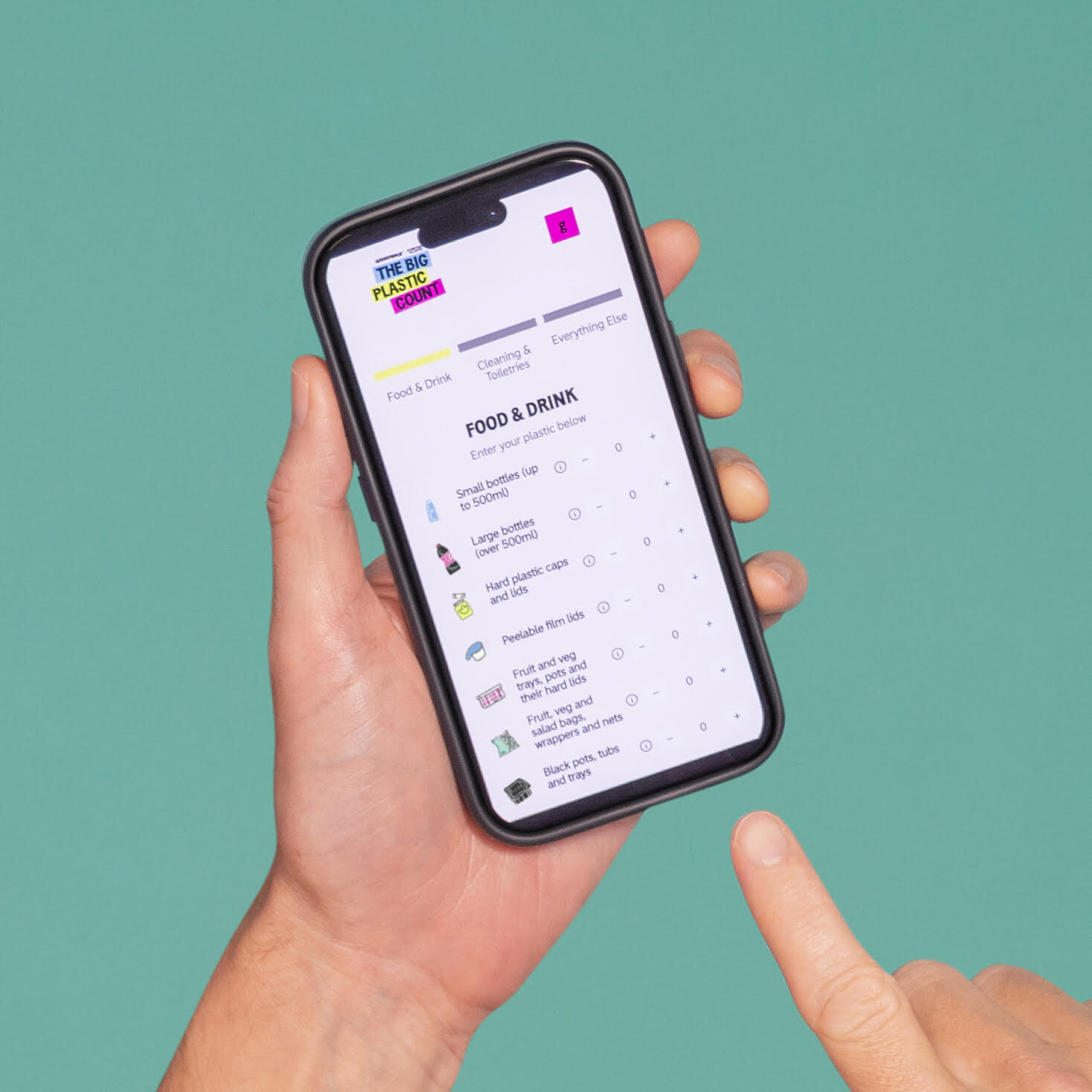 A hand holds a phone, while the other points to The Big Plastic Count app