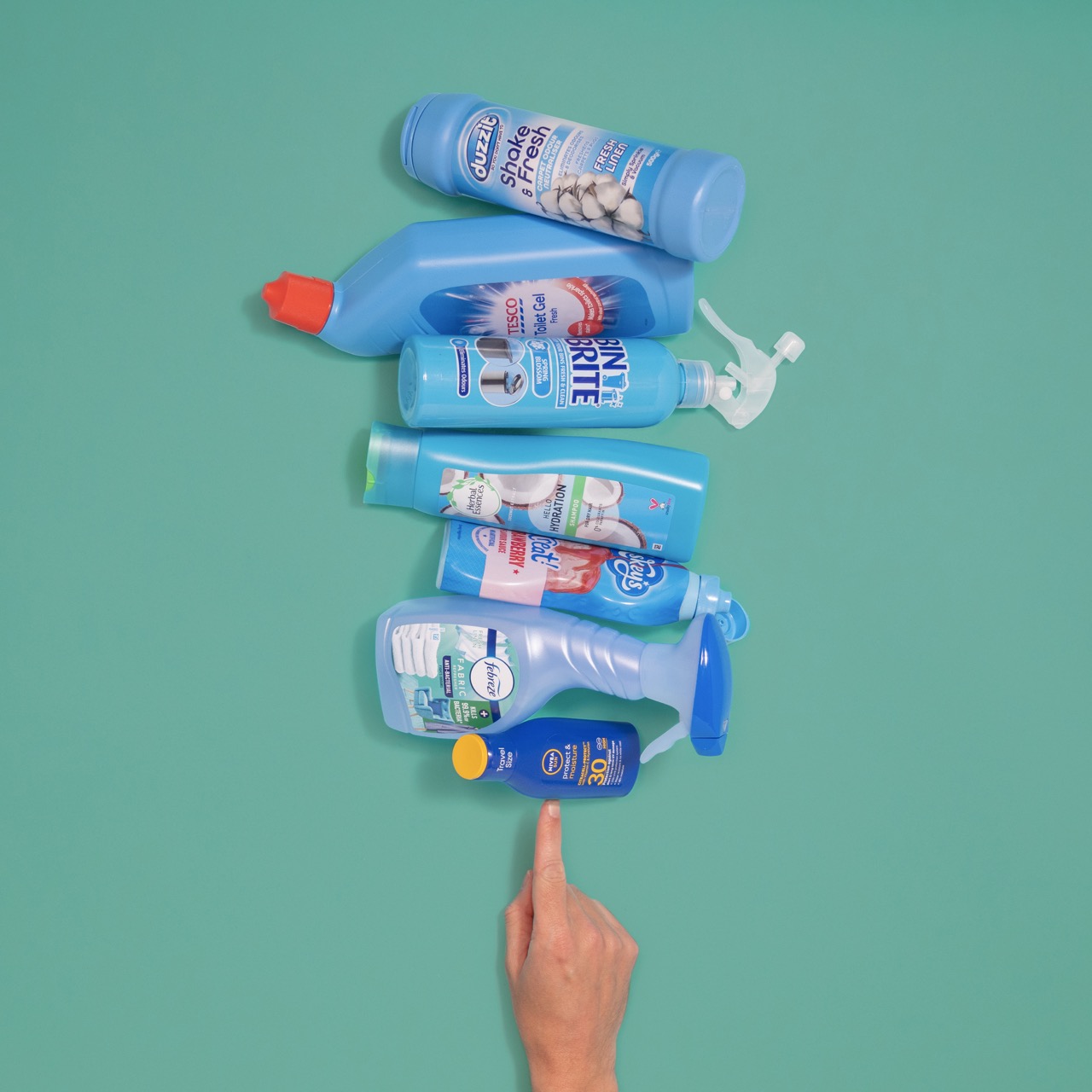 a finger points at products that are all wrapped in blue plastic