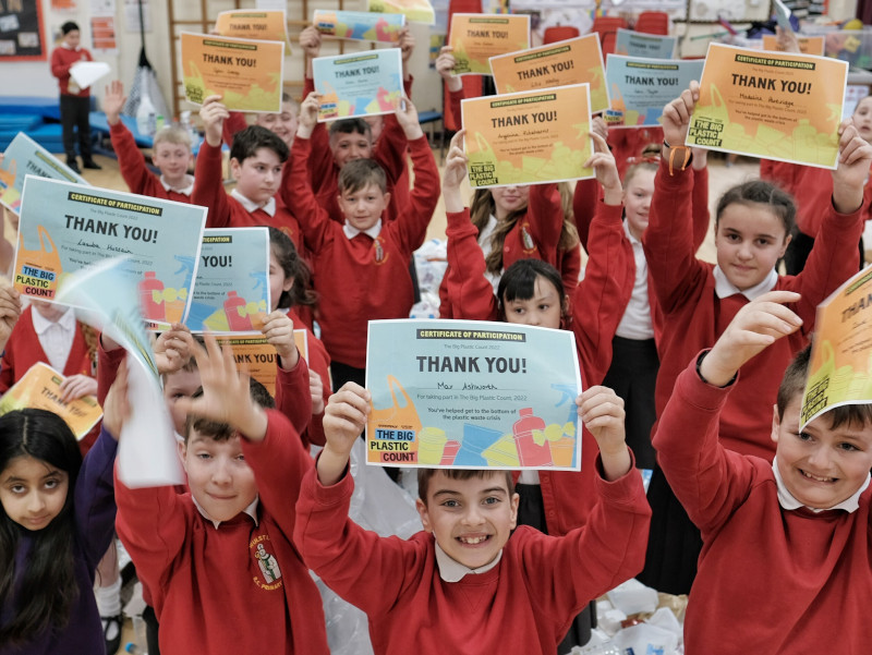 School pupils holding certificates showing that they took part in the The Big Plastic Count
